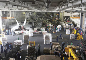100204-N-6604E-124 GULF OF OMAN (Feb. 4, 2010) - Personnel and supplies fill the hangar bay of aircraft carrier USS Dwight D. Eisenhower (CVN 69) during an underway replenishment with fast combat support ship USNS Supply (T-AOE 6). Eisenhower is on a six-month deployment as a part of the on-going rotation of forward-deployed forces to support maritime security operations and operating in international waters around the globe, working with other coalition maritime forces. (U.S. Navy photo by Mass Communication Specialist 3rd Class Bradley Evans/Released).